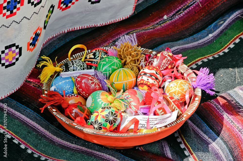 Ukrainian easter eggs on a platter with traditional towel on background