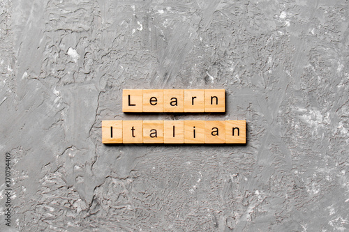learn italian word written on wood block. learn italian text on table, concept