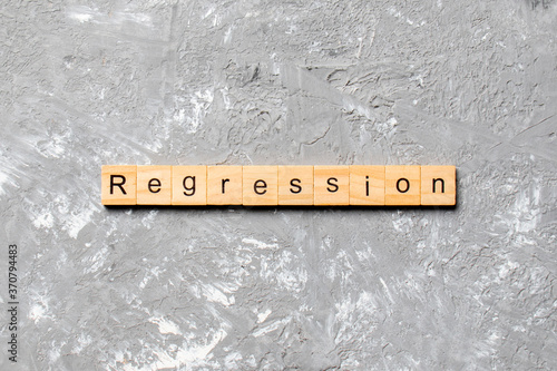 regression word written on wood block. regression text on cement table for your desing, concept