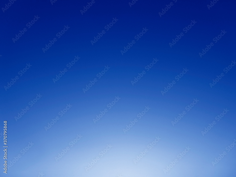 Abstract blue background with light. Clear blue sky and sunshine. Sky and sun background.