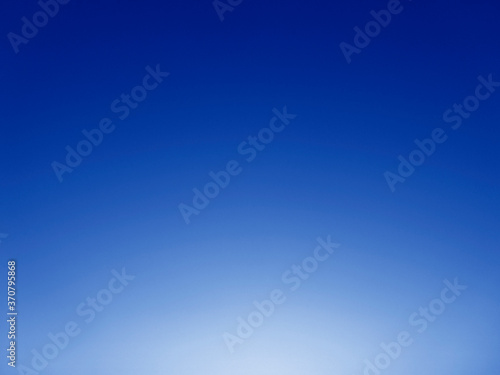 Abstract blue background with light. Clear blue sky and sunshine. Sky and sun background.