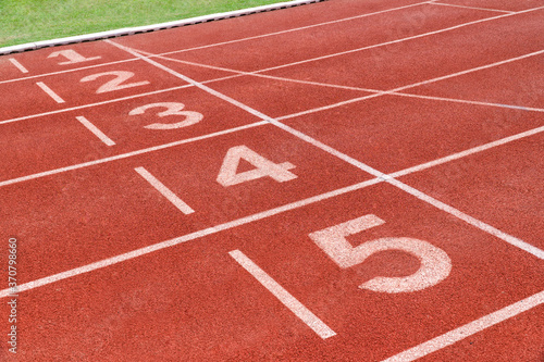 Running track with number in stadium. Close up start position in athlete track. © Thawatchai
