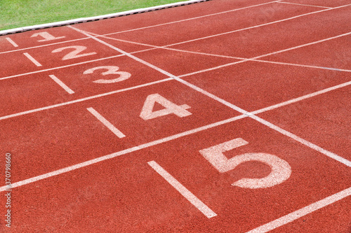 Running track with number in stadium. Close up start position in athlete track.