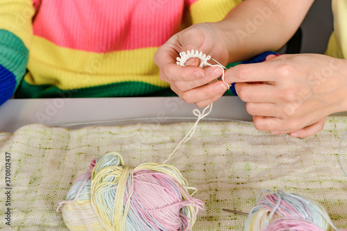 Mom teaches her daughter how to knit.