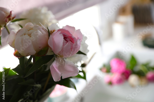 Closeup view of beautiful peonies against blurred background. Space for text