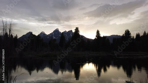 sunset setting behind the mountains at grand tetons National park photo