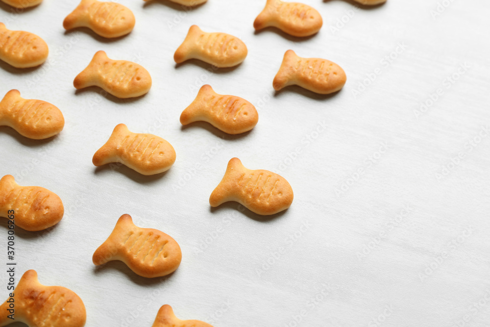 Delicious goldfish crackers on white table, closeup