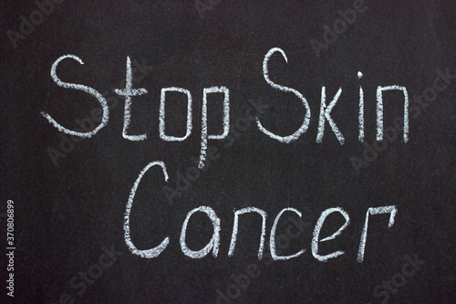  Chalkboard lettering stop skin cancer. A call to strengthen the fight against serious diseases
