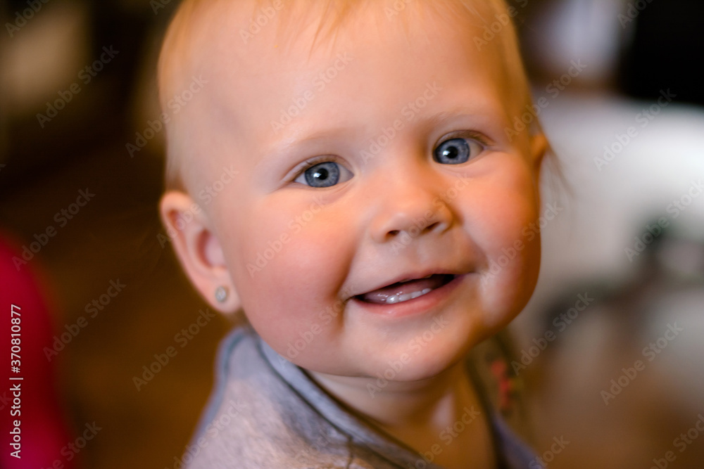 portrait of a smiling baby, european 
girl with blue eyes.