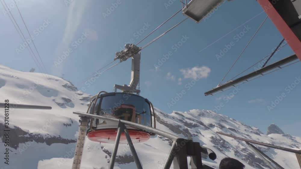 Winter Riding Adventure On A Cable Car Over The Scenic Mount Titlis In Swiss Alps, Switzerland - Medium Shot Winter Riding Adventure On A Cable Car Over The Scenic Mount Titlis In Swiss Alps, Switzerland - Medium Shot