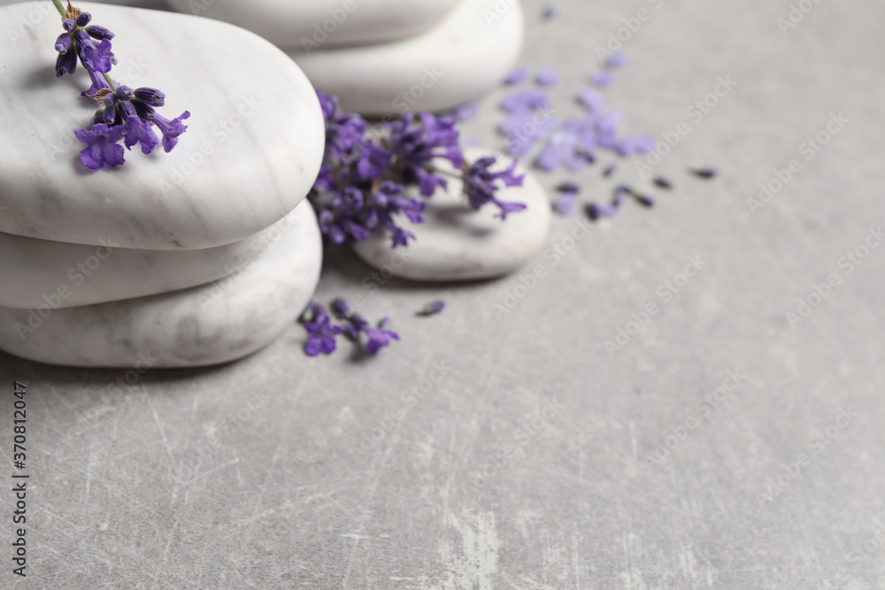 Stones, sea salt and lavender flowers on grey table, closeup. Space for text Stones, sea salt and lavender flowers on grey table, closeup. Space for text