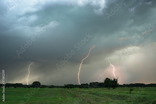 Valokuva Several lightning bolts strike down from a severe thunderstorm in Hungary