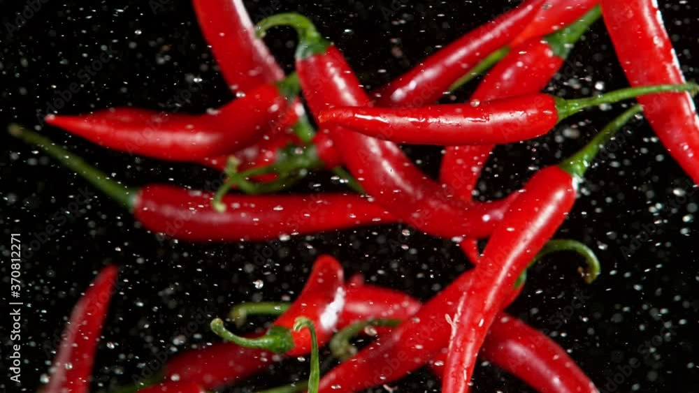 Super Slow Motion Shot of Flying Red Chilli Peppers, Collision in the Air at 1000fps. Super Slow Motion Shot of Flying Red Chilli Peppers, Collision in the Air at 1000fps.