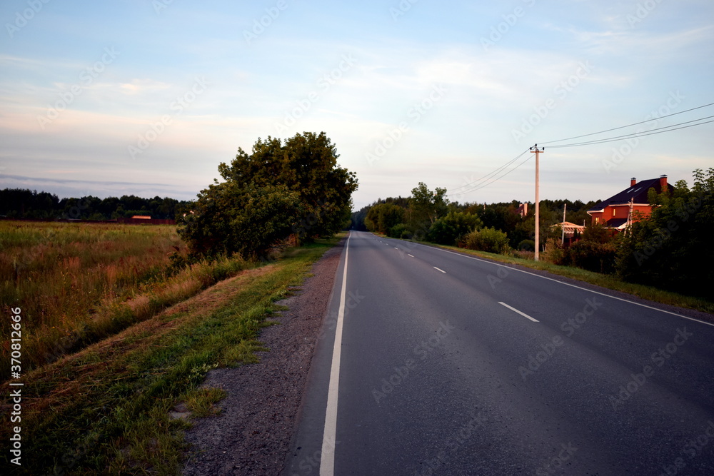 Fototapeta premium dawn on the road, the first rays of the sun