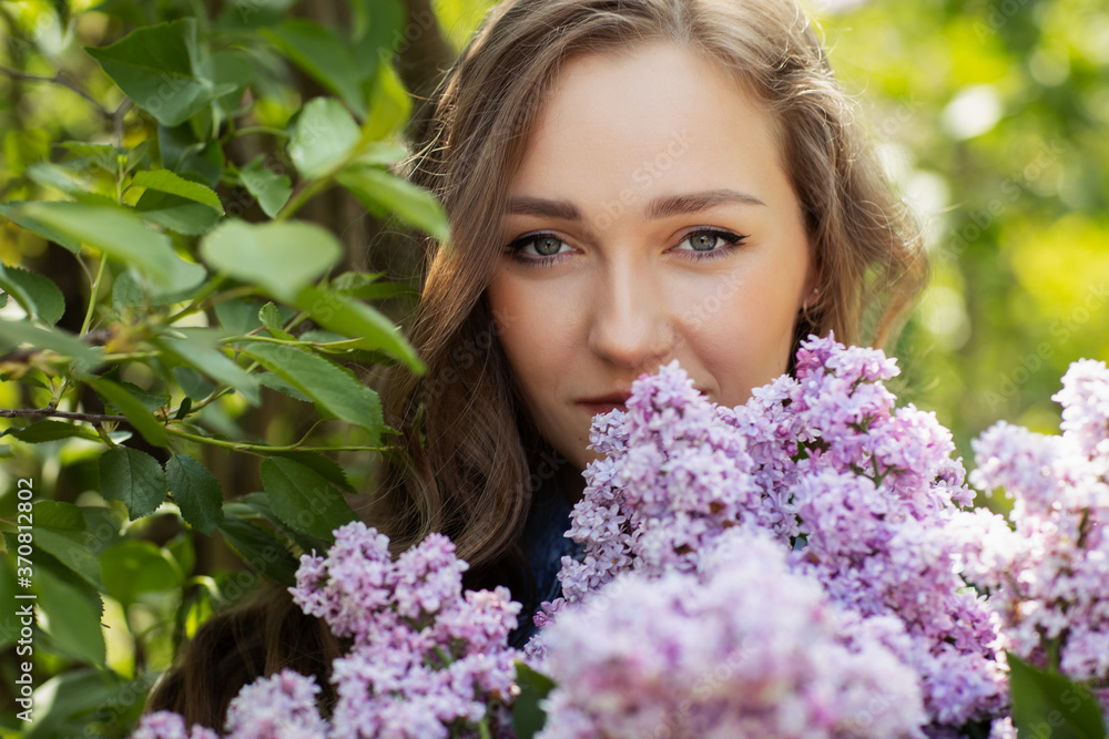 Beautiful Woman Enjoying the Smell of Lilac. Cute Model and Flowers. Aromatherapy and Spring Concept A girl with long hair. Spring lilac blossom Beautiful Woman Enjoying the Smell of Lilac. Cute Model and Flowers. Aromatherapy and Spring Concept A girl with long hair. Spring lilac blossom