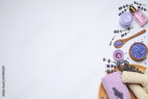 Composition with lavender flowers and natural cosmetic products on white background, top view
