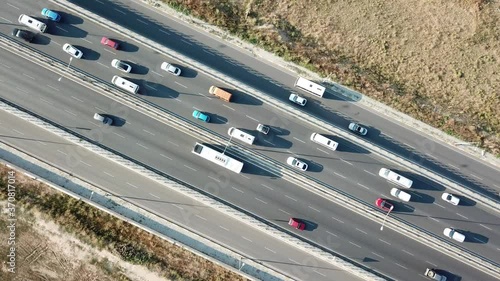 Aerial view of a two-lane expressway or two-lane bridge freeway at the sunset. Vehicles and commercial trucks can be seen. photo