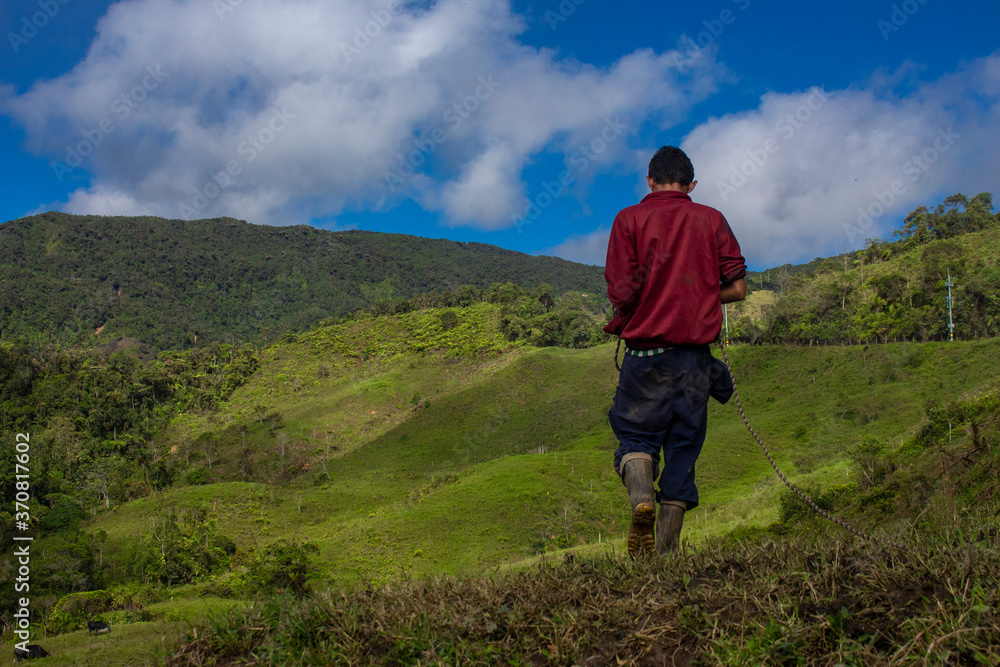 Amaga, Antioquia / Colombia. March 31, 2019. People walking through the countryside in mountainous landscape.