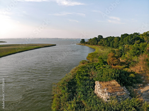 Picturesque coastline. The forest area descends to the coast of the bay along a gentle slope.