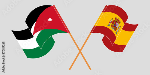 Crossed and waving flags of Jordan and Spain photo