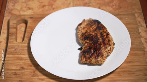 Juicy fried chicken is laid out on a white plate