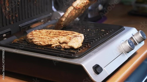 Juicy pieces of chicken meat are grilled and turned over