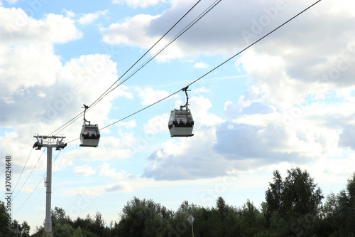 two Cabs cable car against the blue sky with clouds