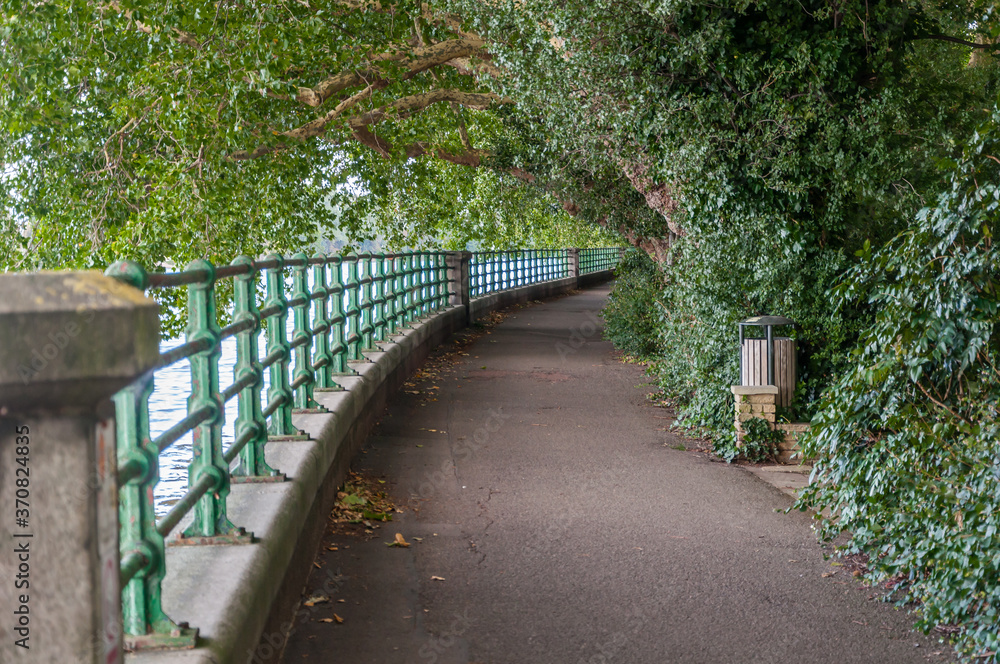 London, United Kingdom - 19 July 2017: The riverbank at Putney looking towards Fulham Palace , Borough of Hammersmith and Fulham London, United Kingdom - 19 July 2017: The riverbank at Putney looking towards Fulham Palace , Borough of Hammersmith and Fulham