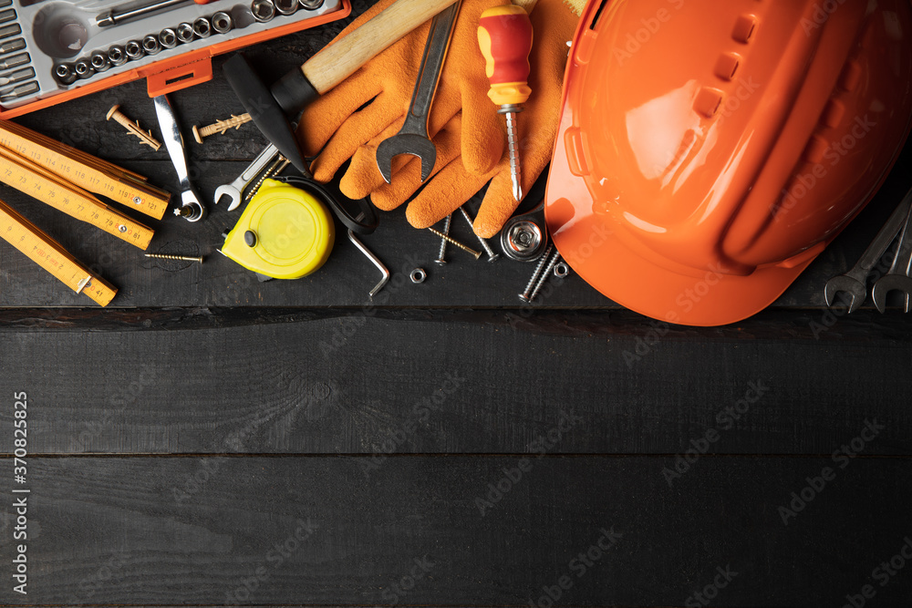 Construction tools on dark wooden background, space for text Construction tools on dark wooden background, space for text