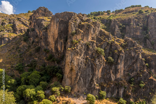 A view past the gorge of Monachil river in the Sierra Nevada mountains, Spain in the summertime