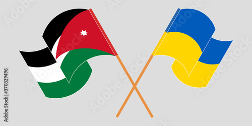 Crossed and waving flags of Jordan and the Ukraine