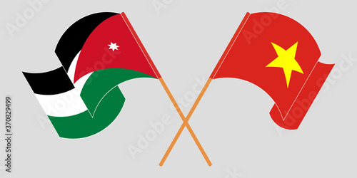 Crossed and waving flags of Jordan and Vietnam