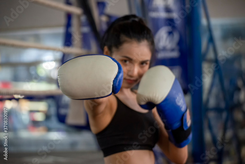 Muay Thai woman and Healthy concept. Boxing Women prepare to train session and kickboxing, workout at thai boxing gym. Fit Female exercise hard to strengthen muscle.