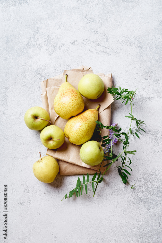 Fresh apples and pears with wild flowers viewed from above Fresh apples and pears with wild flowers viewed from above