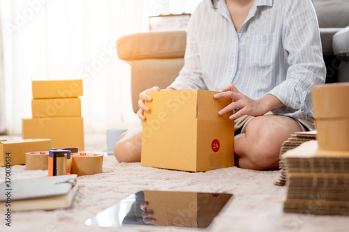 Business woman packing product to send to customer for the online order