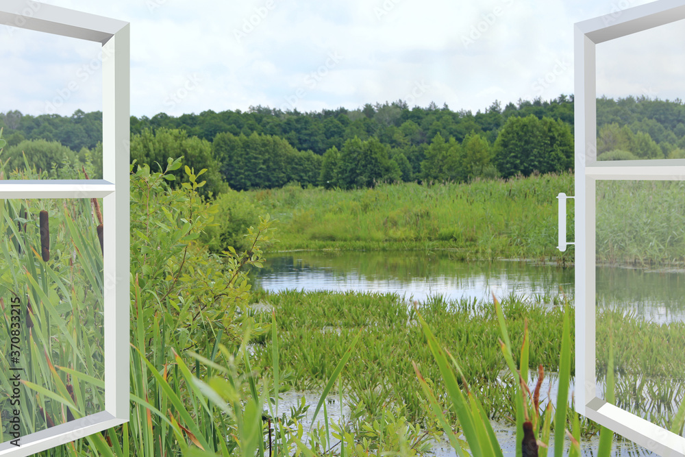 Fototapeta premium Room with wide window overlooking landscape with lake surrounded with cane