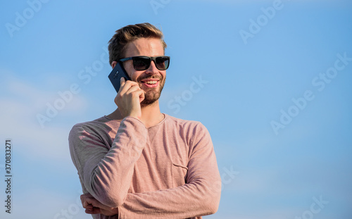 good news. confident man speak on phone. Call to friend. modern technology in life. always in touch. sexy man sky background. macho man use mobile phone. guy casual style. Fashion model © be free