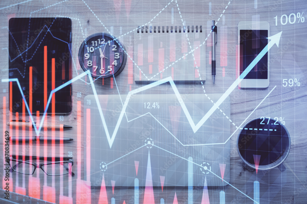 Double exposure of forex graph hologram over desktop with phone. Top view. Mobile trade platform concept. Double exposure of forex graph hologram over desktop with phone. Top view. Mobile trade platform concept.