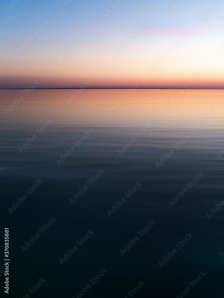Sunrise seascape with an abstract effect. View of the Baltic Sea during the White Nights.