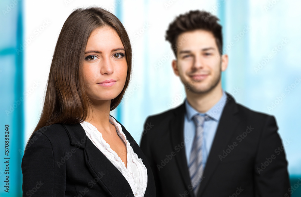 Business partners smiling in a modern office Business partners smiling in a modern office