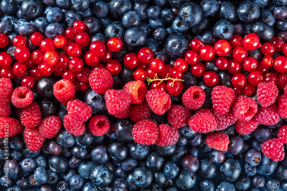 Fresh blueberries, red currants and raspberries texture, shot from the top Fresh blueberries, red currants and raspberries texture, shot from the top