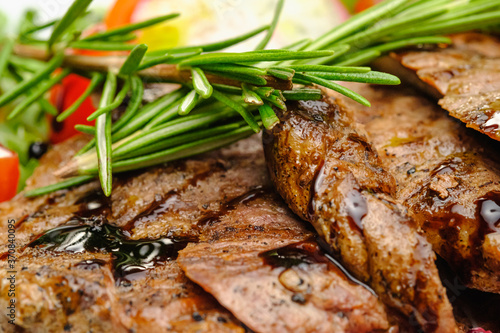 Grilled maso with vegetables and rosemary on a white plate. photo