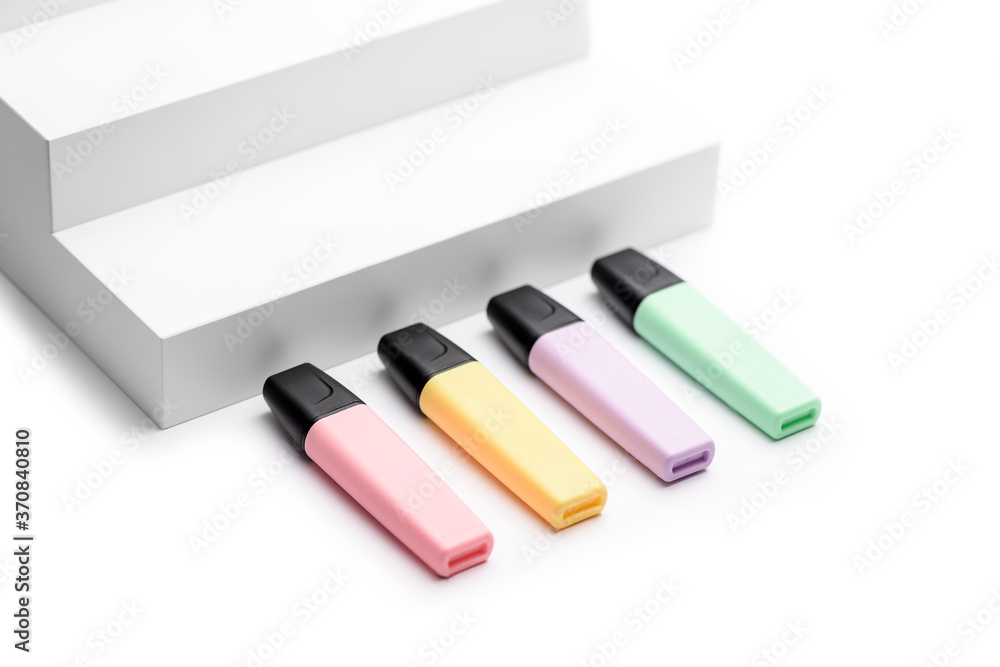 Pastel highlighters on white steps background Pastel highlighters on white steps background
