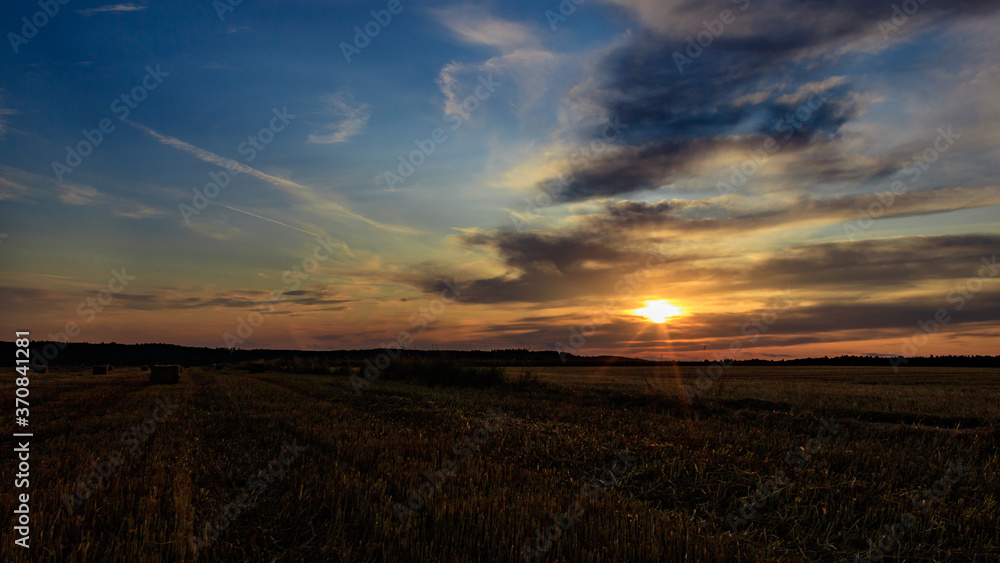 Sunset over agricultural field against cloudy sky in Möckmühl, Germany