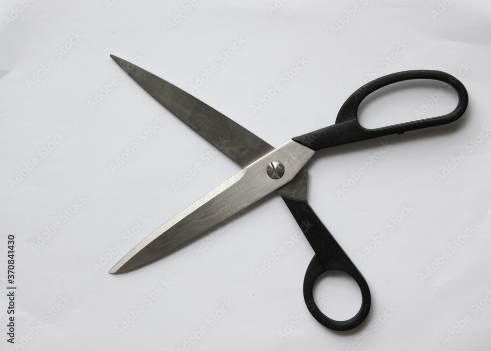 Scissors hand-operated cutting instruments. Scissors for cutting paper and thin materials, object is isolated on white background . Scissors hand-operated cutting instruments. Scissors for cutting paper and thin materials, object is isolated on white background .