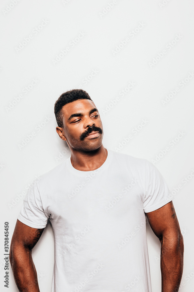 Serious black man with casual outfit posing over white background looking away Serious black man with casual outfit posing over white background looking away