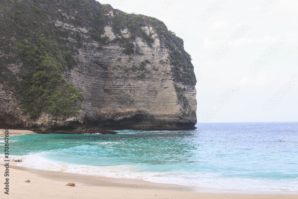 Manta Bay or Kelingking Beach on Nusa Penida Island, Bali, Indonesia. Amazing  view, white sand beach with rocky mountains and azure lagoon with clear water of Indian Ocean 