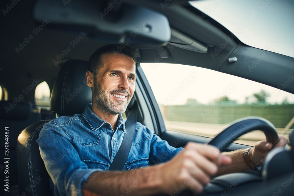 Handsome man driving a car Handsome man driving a car