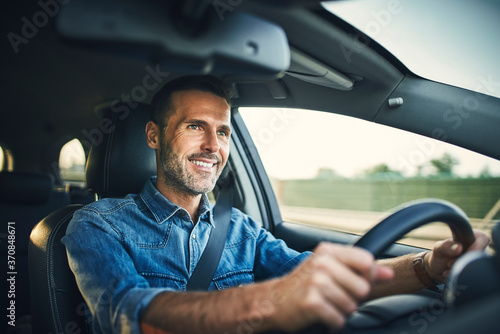 Handsome man driving a car photo