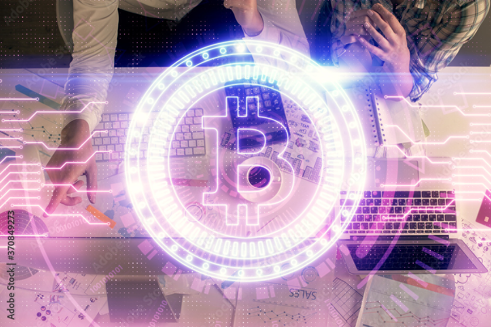 Fototapeta premium Double exposure of man and woman working together and crypto theme hologram drawing. Computer background. Blockchain concept. Top View.